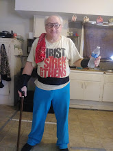 Carl Frye, founder of Primitive Prophetic Artistry, standing with his cane and smiling in a Christ shirt